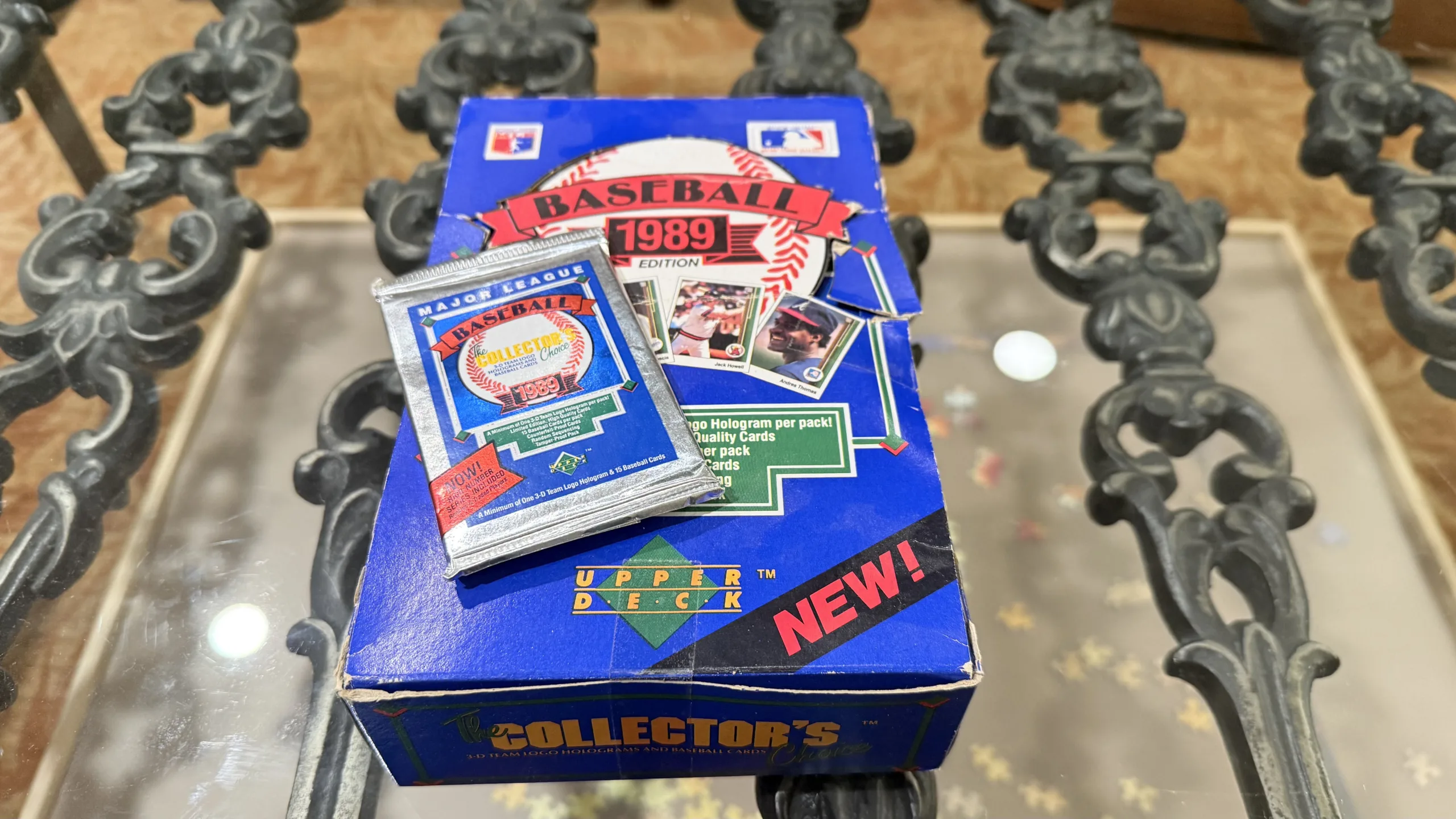 A box of baseball cards and a packet of cards on a table